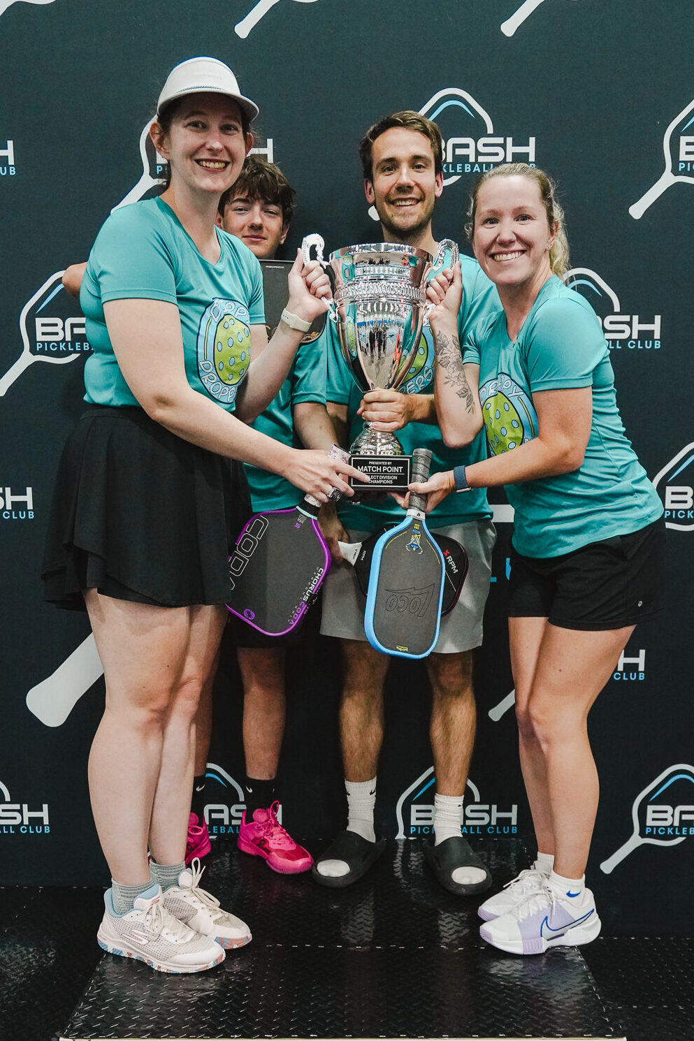 League Match Point Select Division championship team celebrating with the league trophy after winning the title at Bash Pickleball Club in Michigan.